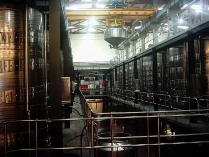 Automated position control 10 ton crane system for gravity feed wine cellar. 